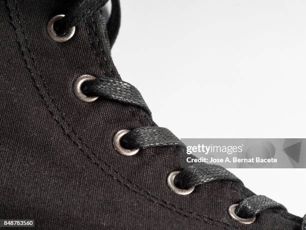 black sneakers  on a white background, with form of boot - black lace background stock pictures, royalty-free photos & images