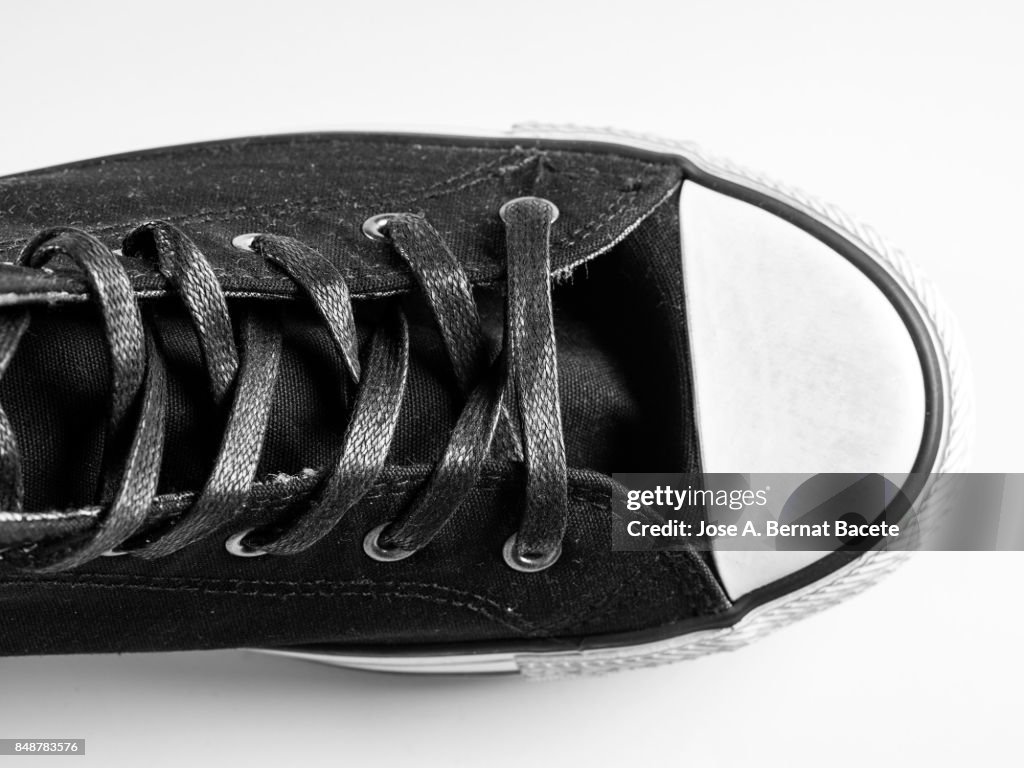 Black sneakers  on a white background, with form of boot