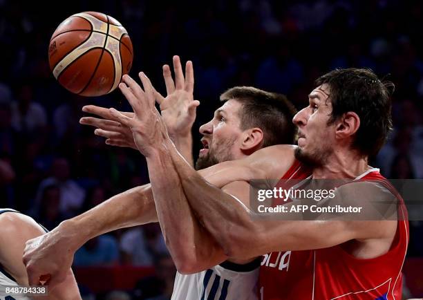 Serbia's center Boban Marjanovich vies for the ball with Slovenia's center Gasper Vidman and Vlatko Cancar during the FIBA Eurobasket 2017 men's...