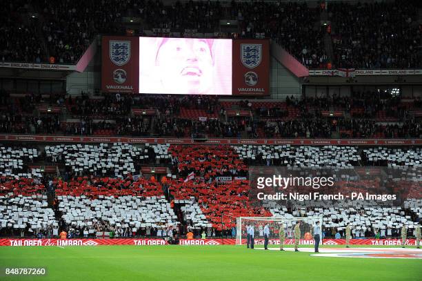 General view as England fans hold coloured cards to create a giant St George's flag in the stands before kick-off