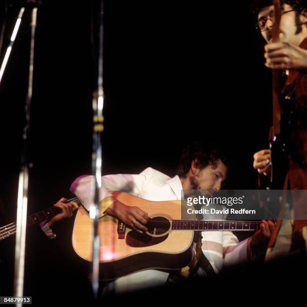 American singer, songwriter and musician Bob Dylan performs live on stage with Rick Danko and Robbie Robertson of the Band at the 1969 Isle of Wight...