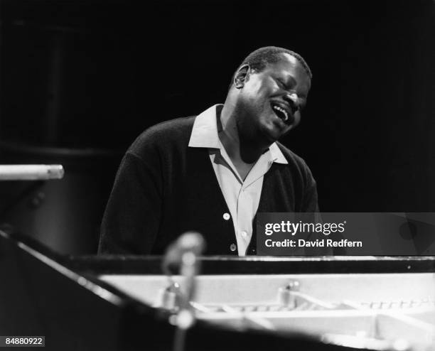 Canadian jazz pianist Oscar Peterson seated at a piano in a television studio circa 1970.
