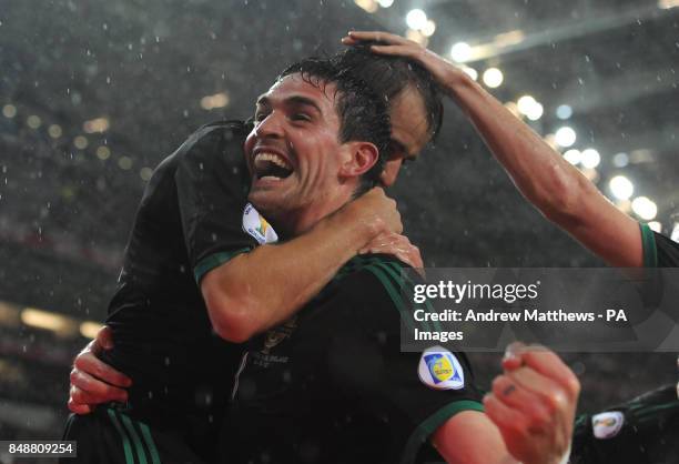 Northern ireland's Niall McGinn celebrates with team mate Kyle Lafferty after scoring during the World Cup Group F Qualifying match at the Estadio do...