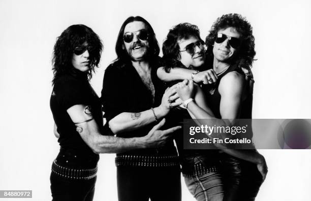 Photo of LEMMY and MOTORHEAD posed in London in July 1984. Left to Right: Mick "Wurzel" Burston, Lemmy Kilmister, Phil Campbell, Pete Gill.