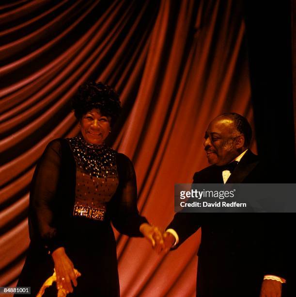 American jazz pianist and composer Count Basie presents American singer Ella Fitzgerald on stage during a concert performance at Annabel's club in...