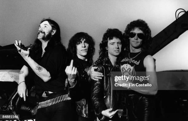 Photo of LEMMY and MOTORHEAD posed in a scrapyard in Pimlico, London in August 1984. Left to Right: Lemmy Kilmister, Mick "Wurzel" Burston, Phil...