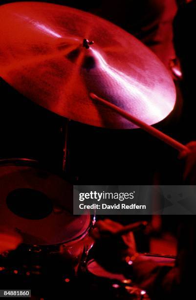 Close up of a ride cymbal on a drum kit being played on stage with a drum stick, circa 1980.