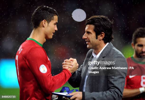 Portugal's Cristiano Ronaldo is presented with a medal by Figo after earning his 100th cap