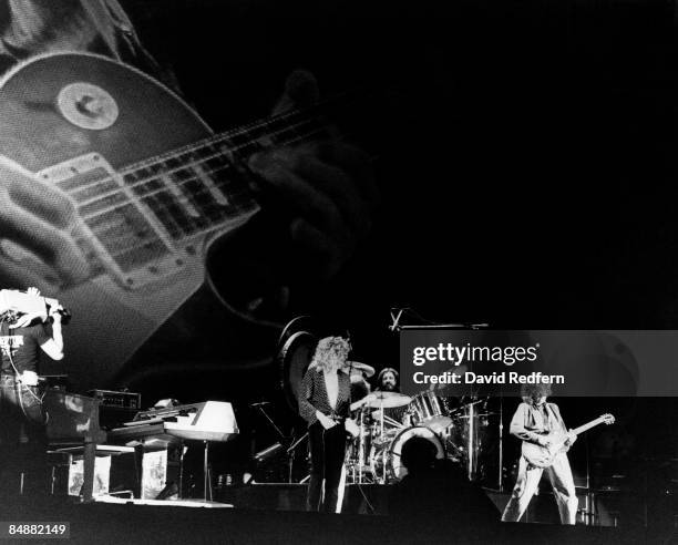 Cameraman films, from left, Robert Plant, John Bonham and Jimmy Page of English rock group Led Zeppelin performing live on stage with a background...