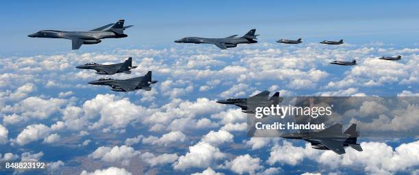 In this handout image provided by South Korean Defense Ministry, U.S. Air Force B-1B Lancer bombers flying with F-35B fighter jets and South Korean...