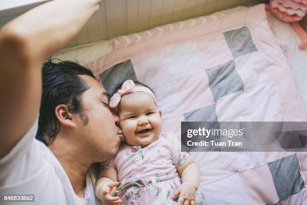 Father kissing baby girl