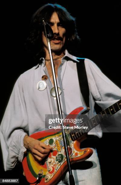 Photo of George HARRISON; performing live onstage on Dark Horse tour, playing 'Rocky' Fender Stratocaster guitar