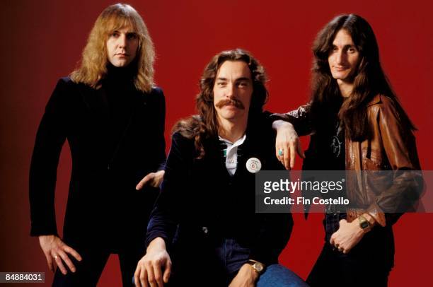 Photo of Neil PEART and RUSH and Alex LIFESON and Geddy LEE; L-R: Alex Lifeson, Neil Peart, Geddy Lee - posed, studio, group shot,