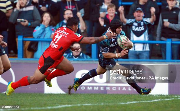 Cardiff Blues' Leigh Halfpenny scores a try despite the tackle of Toulon's David Smith during the Heineken Cup match at Cardiff Arms Park, Cardiff.