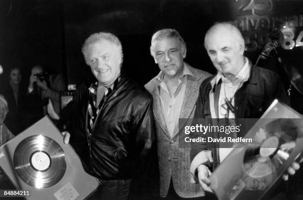 American jazz drummer Buddy Rich posed in centre with club owners Pete King and Ronnie Scott , both holding gold discs, at a jazz event in London in...