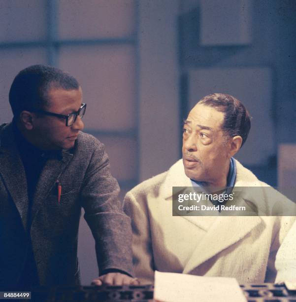 American composer, pianist and bandleader Duke Ellington seated on right with jazz composer and arranger Billy Strayhorn during the recording of the...