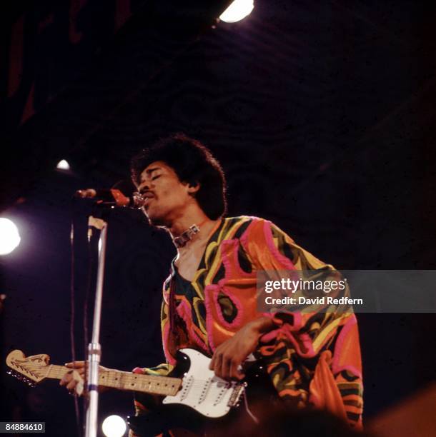 American rock guitarist and singer Jimi Hendrix performs live on stage playing a black Fender Stratocaster guitar at the 1970 Isle of Wight Festival...
