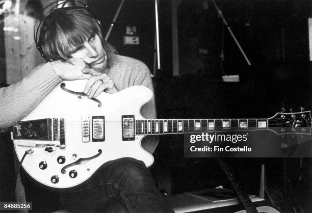 Photo of Alex LIFESON and RUSH; Alex Lifeson posed in recording studio, holding Gibson ES-355 guitar, making Permanent Waves album