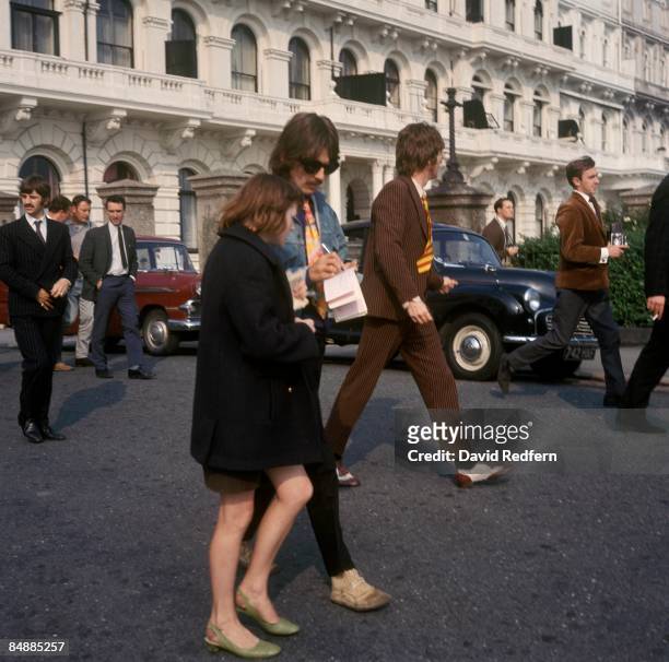 From left, Ringo Starr, George Harrison and John Lennon of English rock and pop group The Beatles walk through Plymouth in Devon during filming of...