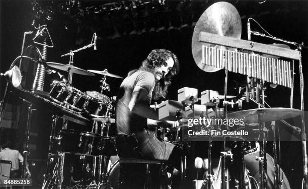 Photo of Neil PEART and RUSH; Neil Peart performing live onstage, showing percussion equipment and drum kit on A Farewell To Kings tour