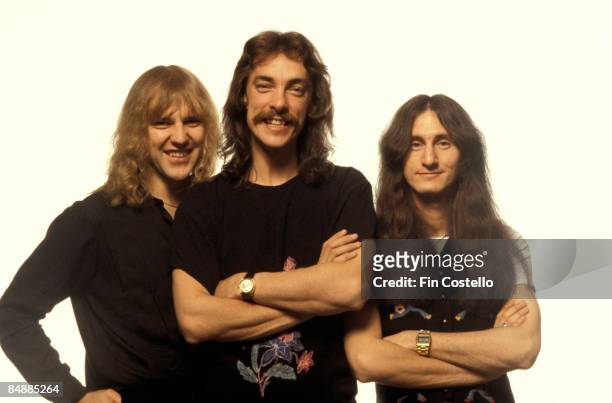 Photo of Neil PEART and RUSH and Alex LIFESON and Geddy LEE; L-R: Alex Lifeson, Neil Peart, Geddy Lee - posed, studio, group shot
