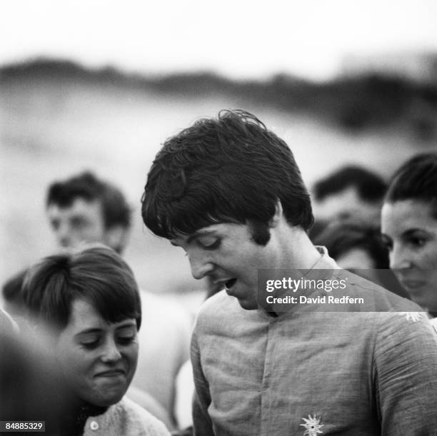 Paul McCartney of English rock and pop group The Beatles signs autographs for fans during filming of the television musical film 'Magical Mystery...