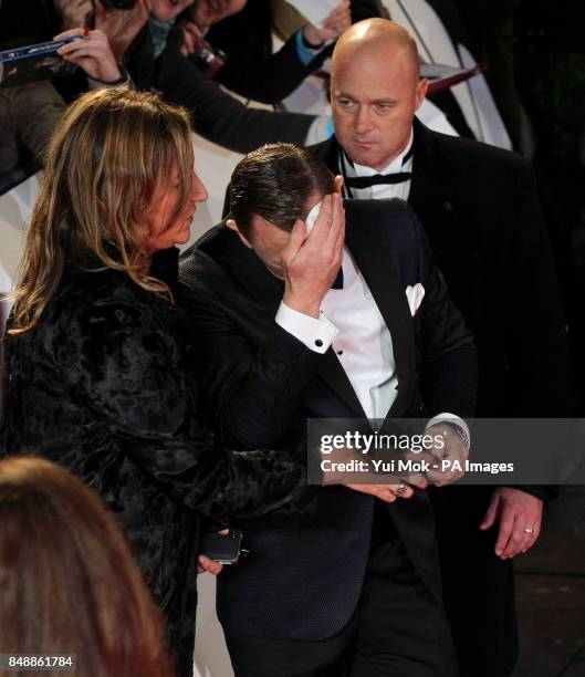 Daniel Craig mops his brow during the world premiere of Skyfall, at the Royal Albert Hall in London.