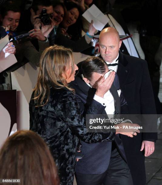 Daniel Craig mops his brow during the world premiere of Skyfall, at the Royal Albert Hall in London.