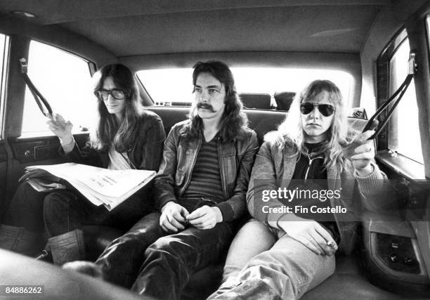 Photo of Neil PEART and RUSH and Geddy LEE and Alex LIFESON, Geddy Lee, Neil Peart, Alex Lifeson - posed, group shot, sitting in car during A...