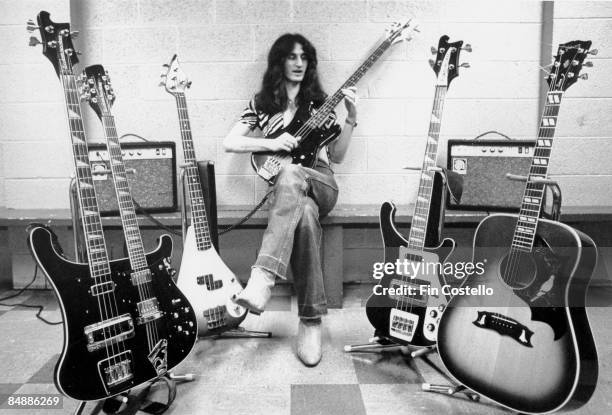 Photo of Geddy LEE and RUSH, Geddy Lee posed, backstage with guitar collection on All The World's A Stage tour