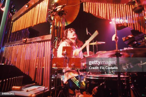 Photo of Neil PEART and RUSH; Neil Peart performing live onstage, with percussion instruments on All The World's A Stage tour,