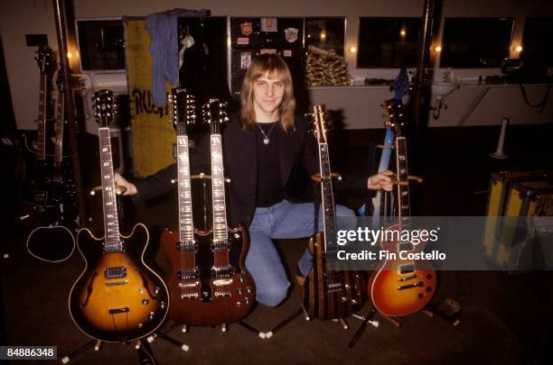 Photo of Alex LIFESON and RUSH; Alex Lifeson, posed in studio with guitar collection,