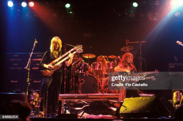 Photo of RUSH; L-R: Alex Lifeson, Geddy Lee performing live onstage, with Marshall amplifiers behind, on All The World's A Stage tour,