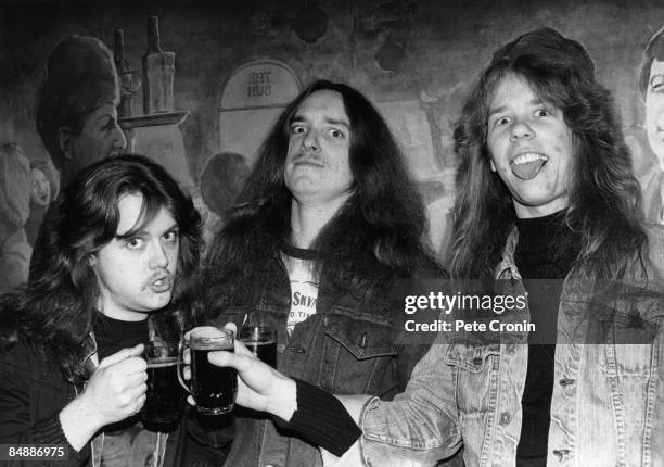 Photo of James HETFIELD and METALLICA and Lars ULRICH and Cliff BURTON, L-R: Lars Ulrich, Cliff Burton, James Hetfield - posed, drinking beer