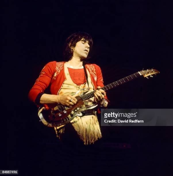 English guitarist Keith Richards of The Rolling Stones performs live on stage playing an Ampeg Dan Armstrong perspex guitar at Colston Hall in...