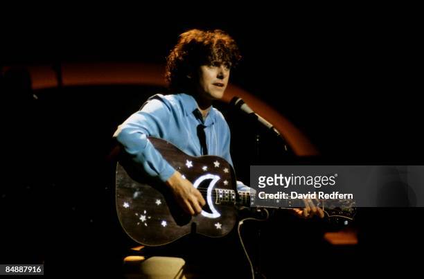 Scottish singer and musician Donovan performs with an acoustic guitar decorated with crescent moon and stars on a television show circa 1973.