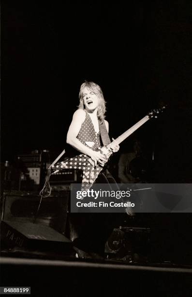 Photo of Randy RHOADS; performing live onstage with Ozzy Osbourne's band, playing Jackson guitar