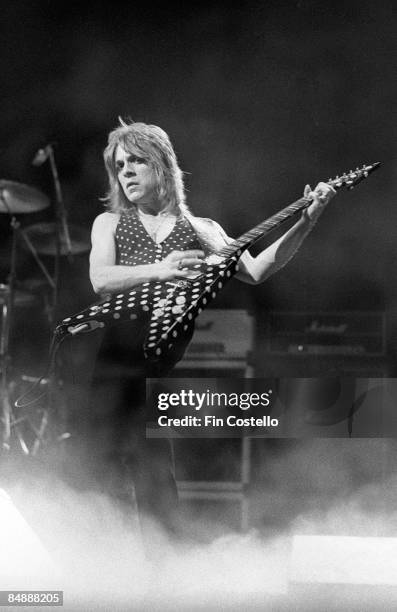 Photo of Randy RHOADS; performing live onstage with Ozzy Osbourne's band, playing Jackson guitar