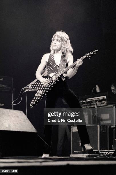 Photo of Randy RHOADS; performing live onstage with Ozzy Osbourne's band, playing Jackson guitar