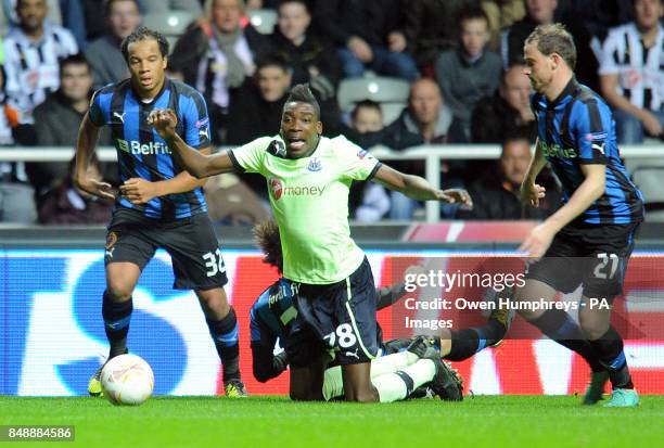 Newcastle United's Sammy Ameobie is challenged from behind by Club Brugge's Figueras Jordi during the UEFA Europa League match at St James' Park,...