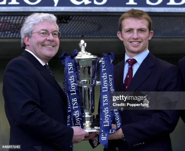 Peter Ellwood, Chief Executive of the Lloyds TSB Group , presents the Six Nations Rugby trophy to England captain Matt Dawson at Twickenham in London...