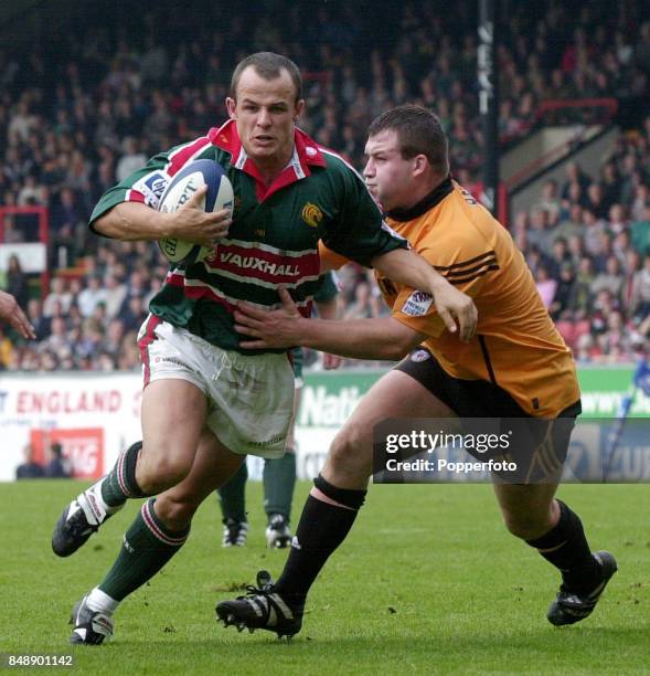Austin Healey of Leicester attempts to get past Mark Regan of Bath during the Zurich Premiership match between Leicester Tigers and Bath at Welford...