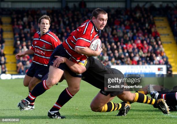 Trevor Woodman of Gloucester is tackled by Craig Dowd of London Wasps during the Zurich Premiership match between Wasps and Gloucester at Adams Park,...
