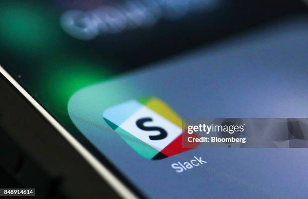 The icon for the chat service app Slack, by Slack Technologies Inc., sits on the screen of an Apple Inc. IPhone 6 smartphone in this arranged...