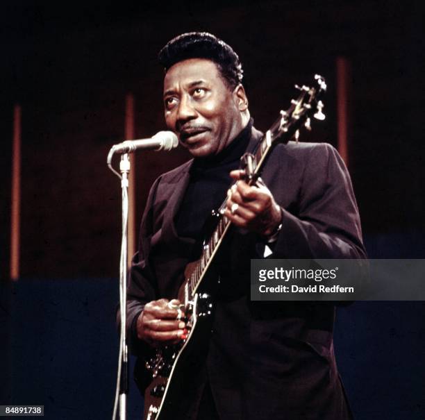 American blues singer and guitarist Muddy Waters performs live on stage with his blues band during the recording of the BBC Television show 'Jazz at...