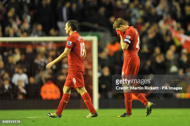 Liverpool's Stewart Downing and Steven Gerrard walk dejected on the pitch