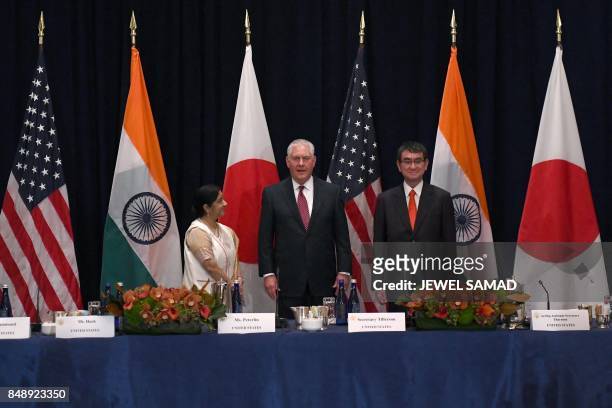 Secretary of State Rex Tillerson answers a question as India's Foreign Minister Sushma Swaraj and Japan's Foreign Minister Taro Kono look on, before...