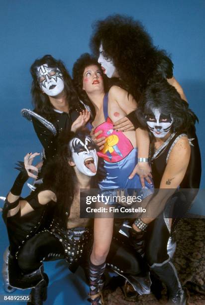 Photo of Ace FREHLEY and KISS and Peter CRISS and Gene SIMMONS and Paul STANLEY; L-R: Ace Frehley, Gene Simmons, model, Paul Stanley, Peter Criss -...