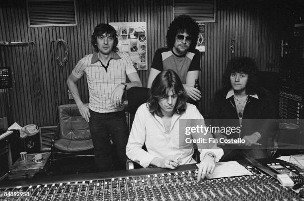 Photo of Richard TANDY and Bev BEVAN and Jeff LYNNE and ELECTRIC LIGHT ORCHESTRA, L-R: Richard Tandy, ?, Jeff Lynne, Bev Bevan in a recording studio...