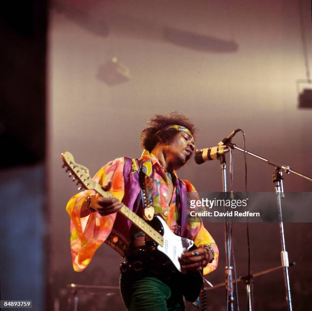 American rock guitarist and singer Jimi Hendrix performs live on stage playing a black Fender Stratocaster guitar with The Jimi Hendrix Experience at...